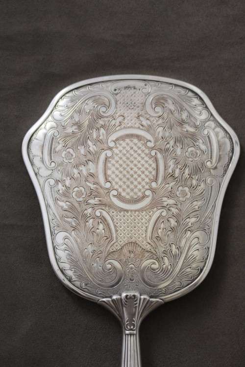 A beautiful antique vanity brush & mirror set w gorgeous pressed detailing.
