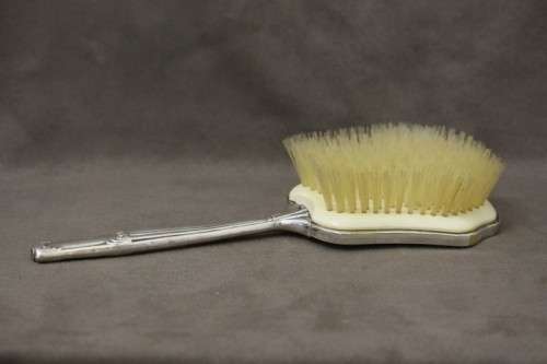 A beautiful antique vanity brush & mirror set w gorgeous pressed detailing.