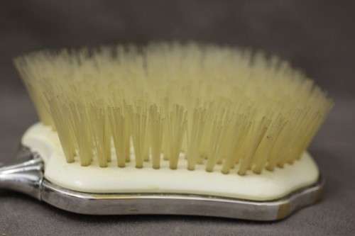 A beautiful antique vanity brush & mirror set w gorgeous pressed detailing.