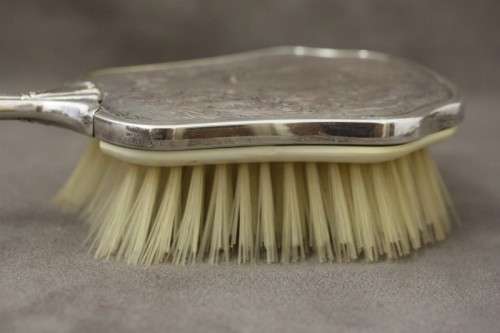 A beautiful antique vanity brush & mirror set w gorgeous pressed detailing.