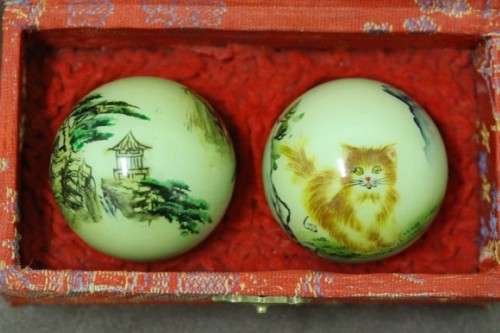 A stunning boxed set of hand painted, scenery themed Chinese cloisonne enamelled Ben-wa balls