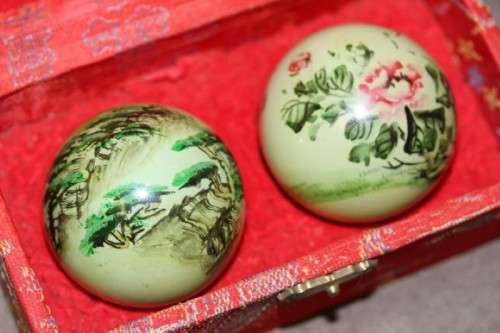 A stunning boxed set of hand painted, scenery themed Chinese cloisonne enamelled Ben-wa balls
