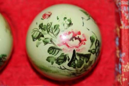 A stunning boxed set of hand painted, scenery themed Chinese cloisonne enamelled Ben-wa balls