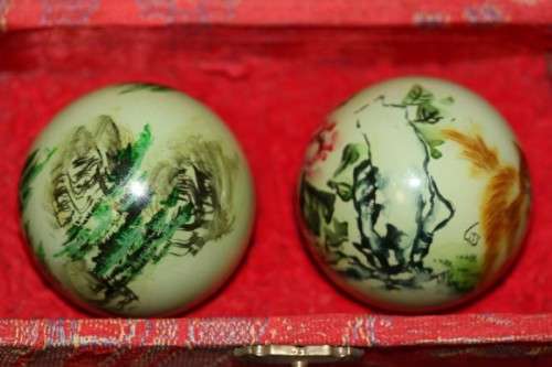 A stunning boxed set of hand painted, scenery themed Chinese cloisonne enamelled Ben-wa balls