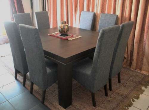 A stunning, new ultra modern 8 seater square dining room table w/ 8 high back upholstered chairs!