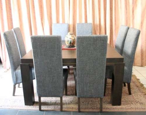 A stunning, new ultra modern 8 seater square dining room table w/ 8 high back upholstered chairs!