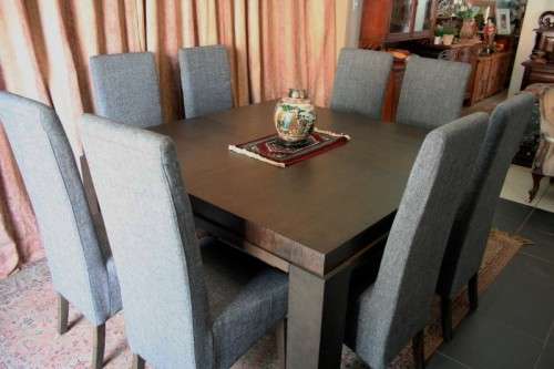 A stunning, new ultra modern 8 seater square dining room table w/ 8 high back upholstered chairs!