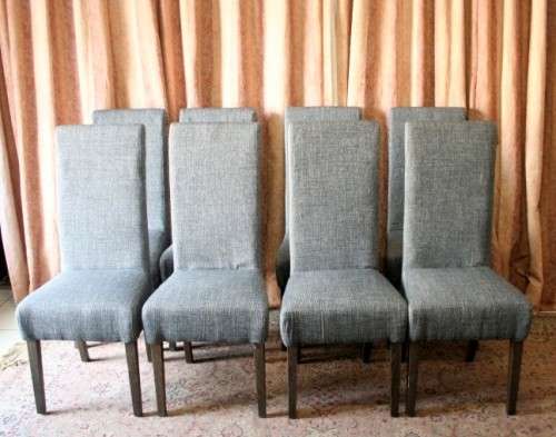 A stunning, new ultra modern 8 seater square dining room table w/ 8 high back upholstered chairs!