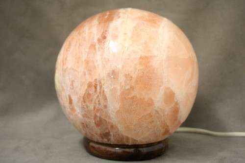 An amazing Himalayan Crystal Salt lamp on a wooden base in complete working condition