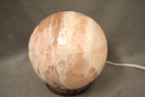 An amazing Himalayan Crystal Salt lamp on a wooden base in complete working condition