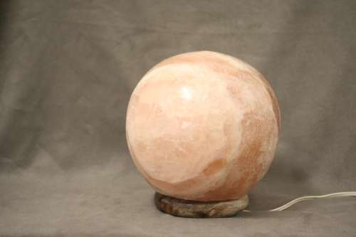 An amazing Himalayan Crystal Salt lamp on a wooden base in complete working condition