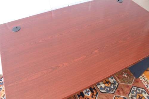 A lovely cherry-wood colour and black framed 120cm office/ study desk - perfect for a smaller space