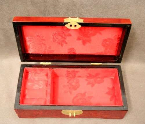 A beautifully made wooden Chinese jewellery box with brass latch and hinges.