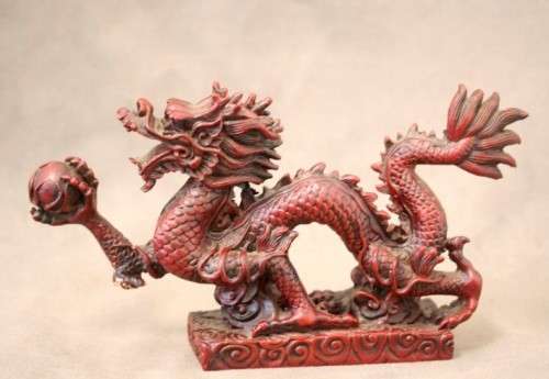 A fabulous red resin Oriental dragon figurine. Stunning on display