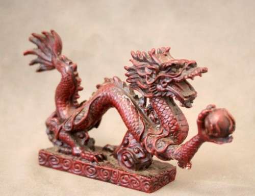 A fabulous red resin Oriental dragon figurine. Stunning on display