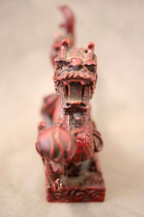 A fabulous red resin Oriental dragon figurine. Stunning on display