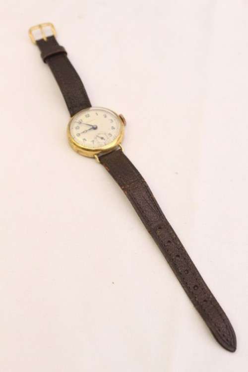 A very pretty & rare round-faced Viola gold filled mechanical ladies wrist watch w/ a leather strap