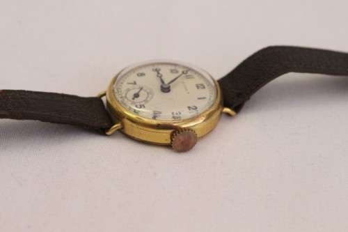 A very pretty & rare round-faced Viola gold filled mechanical ladies wrist watch w/ a leather strap