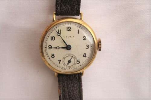 A very pretty & rare round-faced Viola gold filled mechanical ladies wrist watch w/ a leather strap