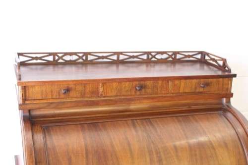 A magnificently made walnut barrel-roll top writing desk with an array of drawers and pigeon holes