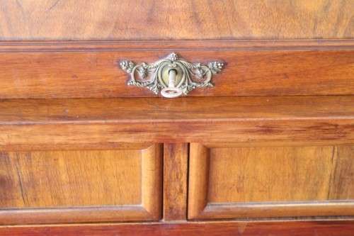 A magnificently made walnut barrel-roll top writing desk with an array of drawers and pigeon holes