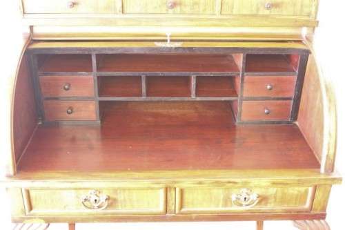 A magnificently made walnut barrel-roll top writing desk with an array of drawers and pigeon holes