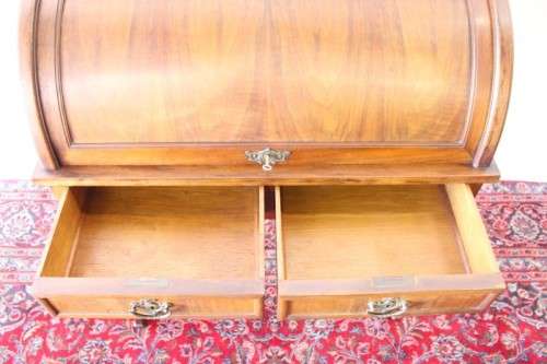 A magnificently made walnut barrel-roll top writing desk with an array of drawers and pigeon holes
