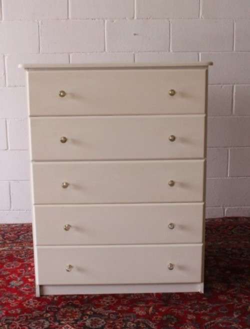 A stunning white 5-drawer chest of drawers with crystal/ glass? handles and ample storage space