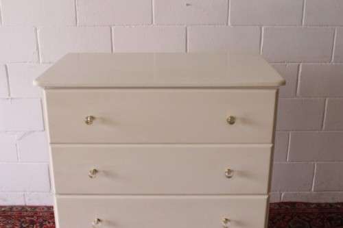 A stunning white 5-drawer chest of drawers with crystal/ glass? handles and ample storage space