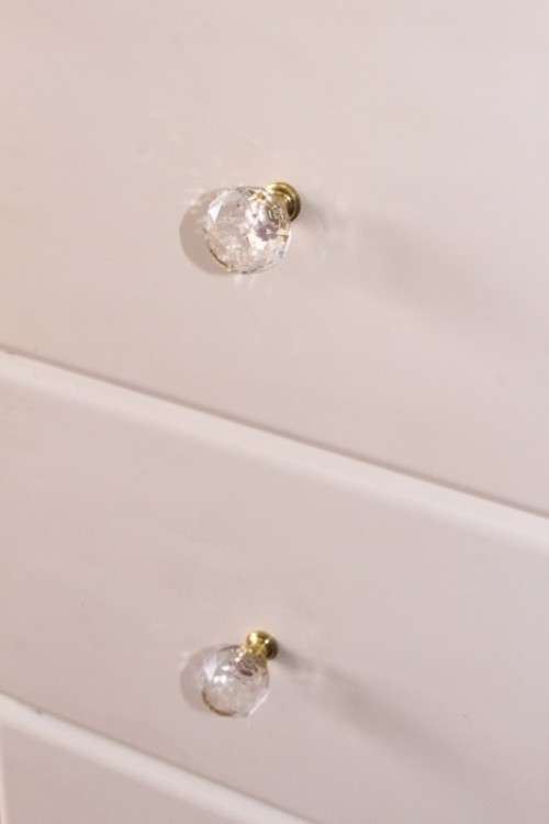 A stunning white 5-drawer chest of drawers with crystal/ glass? handles and ample storage space