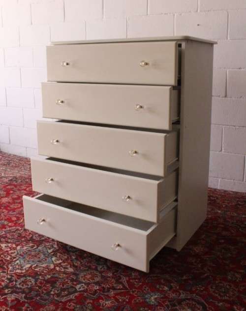 A stunning white 5-drawer chest of drawers with crystal/ glass? handles and ample storage space