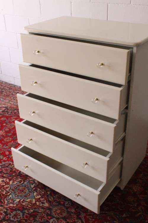 A stunning white 5-drawer chest of drawers with crystal/ glass? handles and ample storage space