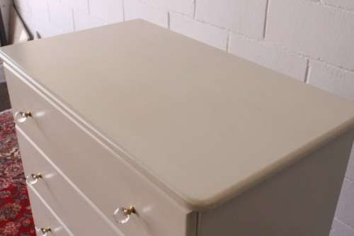 A stunning white 5-drawer chest of drawers with crystal/ glass? handles and ample storage space