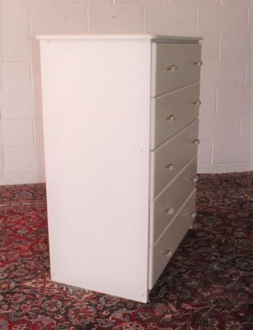 A stunning white 5-drawer chest of drawers with crystal/ glass? handles and ample storage space