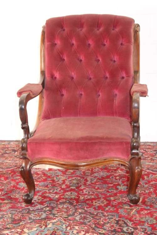 A stunningly hand carved antique walnut "Art Nouveau" reading chair with deep button detailing