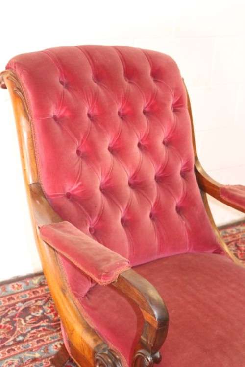 A stunningly hand carved antique walnut "Art Nouveau" reading chair with deep button detailing
