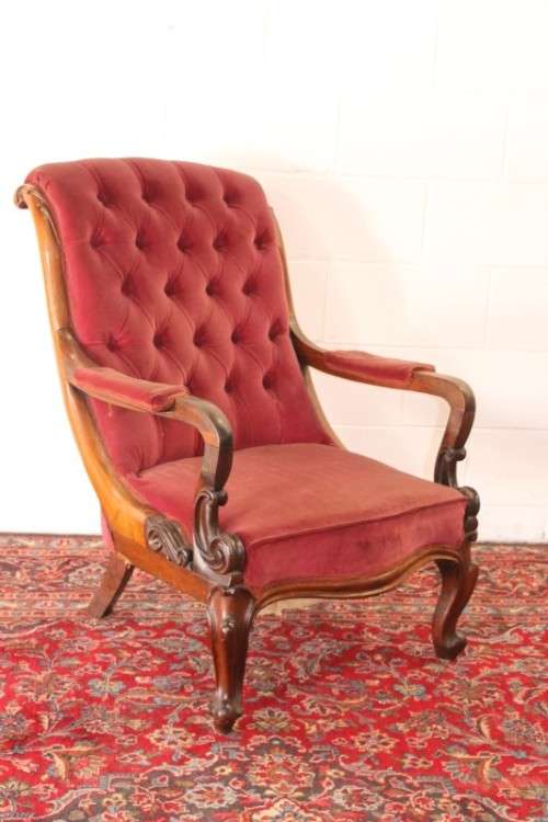 A stunningly hand carved antique walnut "Art Nouveau" reading chair with deep button detailing