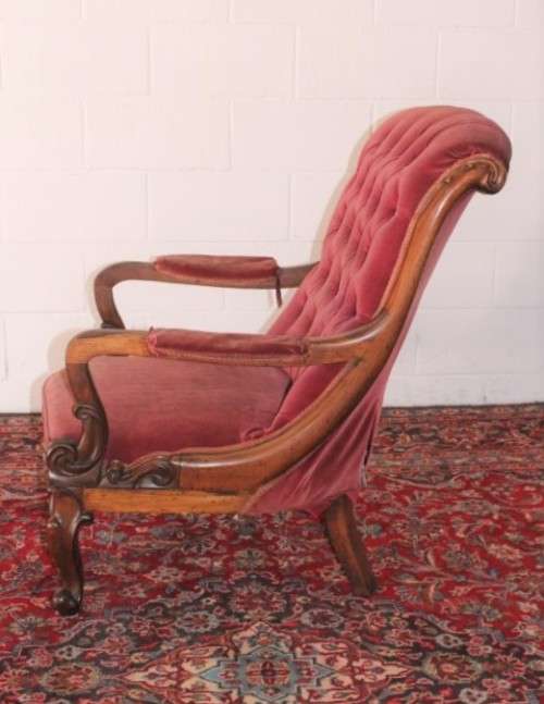 A stunningly hand carved antique walnut "Art Nouveau" reading chair with deep button detailing
