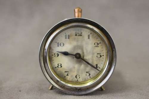 A gorgeous vintage mini round silver metal wind up clock, working.