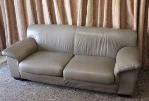 A lovely well made (206cm long) 2 seater beige faux leather couch. Perfect in informal rooms