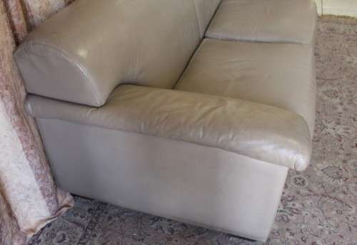 A lovely well made (206cm long) 2 seater beige faux leather couch. Perfect in informal rooms