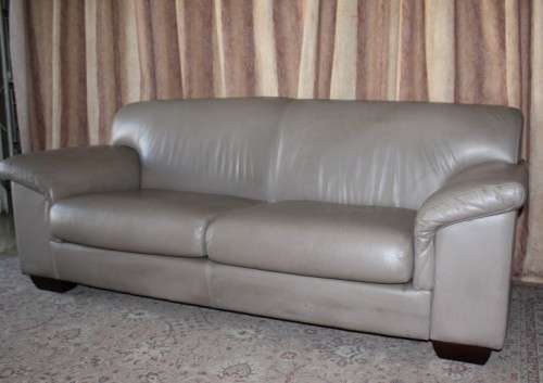 A lovely well made (206cm long) 2 seater beige faux leather couch. Perfect in informal rooms