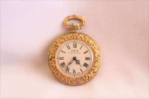 A stunning ornate vintage gold plated 7-Jewel Swiss made Oris ladies pocket watch