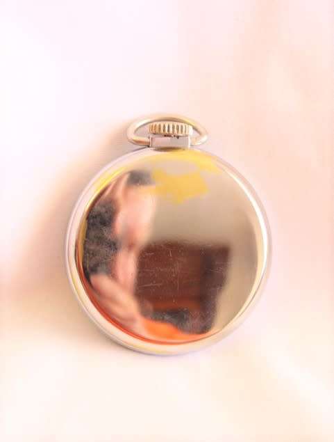 A gorgeous antique Canadian made Westclox Zobo chrome plated open-face pocket watch with a fob chain