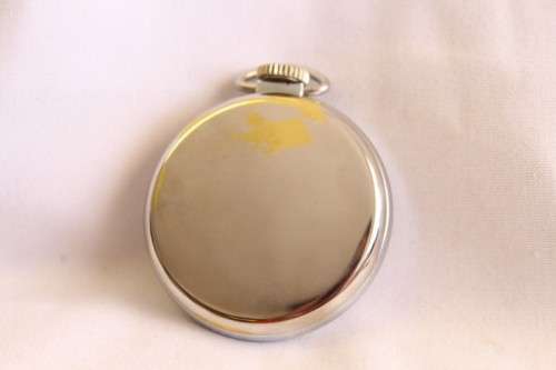 A gorgeous antique Canadian made Westclox Zobo chrome plated open-face pocket watch with a fob chain