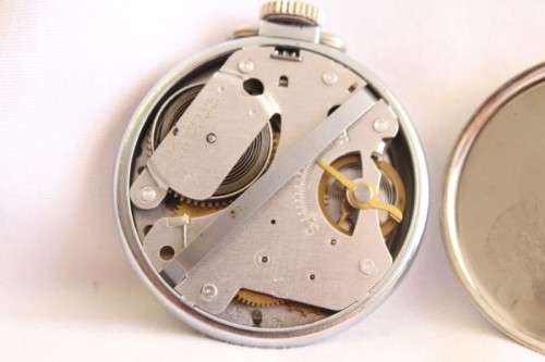 A gorgeous antique Canadian made Westclox Zobo chrome plated open-face pocket watch with a fob chain