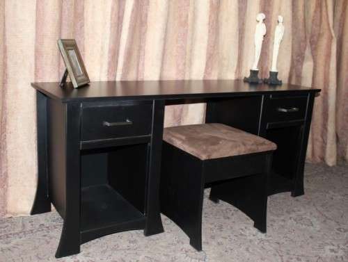 A stunning modern styled black wooden dressing table with two drawers and a suede stool.