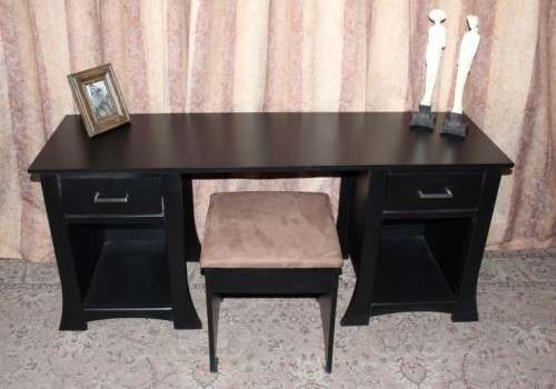 A stunning modern styled black wooden dressing table with two drawers and a suede stool.