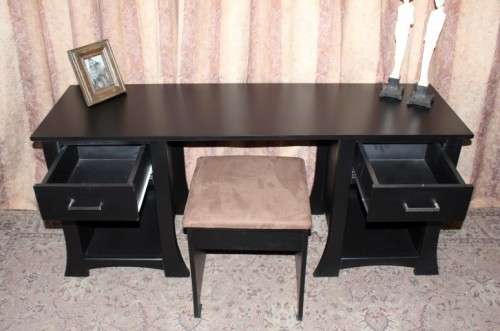 A stunning modern styled black wooden dressing table with two drawers and a suede stool.