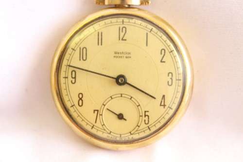 An awesome USA made Westclox Pocket Ben gold plated open-face pocket watch with a fob chain